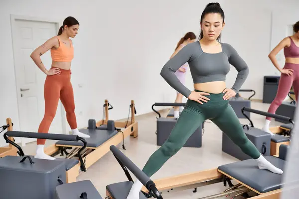 Pretty sporty women fully engaged in a Pilates class. — Stock Photo