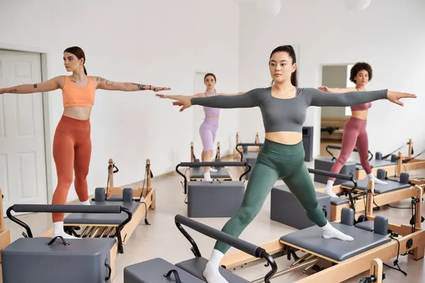 A group of pretty sporty women gracefully practicing pilates in a class. — Stock Photo
