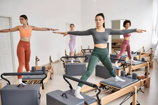 Elegant women gracefully practicing Pilates in a group setting. — Stock Photo