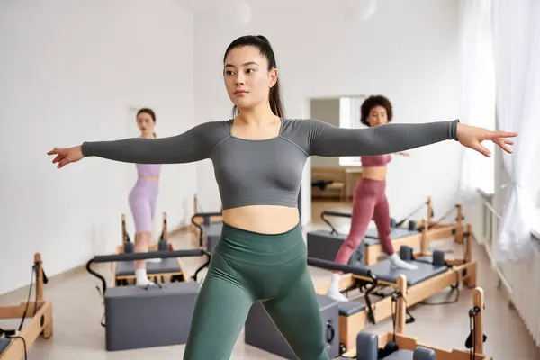 Sporty women engaging in a dynamic Pilates class. — Stock Photo