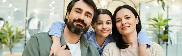A joyful family poses together in an office setting for a memorable photograph. — Stock Photo