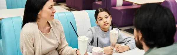 A woman and child sit happily at a table in a restaurant, sharing drinks and bonding during a weekend outing. — Stock Photo