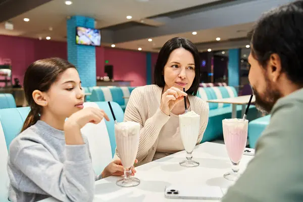 A happy family enjoys quality time at a restaurant, sitting together at a table — Stock Photo