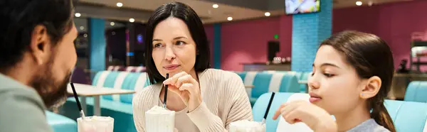 A happy family enjoying quality time together in a modern restaurant during the weekend. — Stock Photo