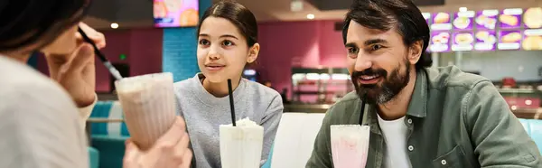 A happy family enjoying quality time together at a modern cafe — Stock Photo