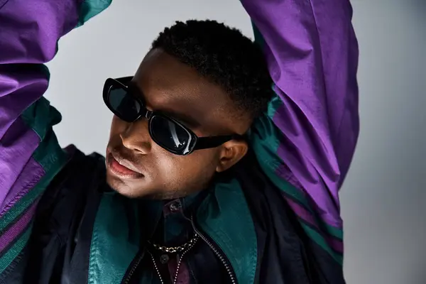 Handsome man with sunglasses and purple jacket. — Stock Photo