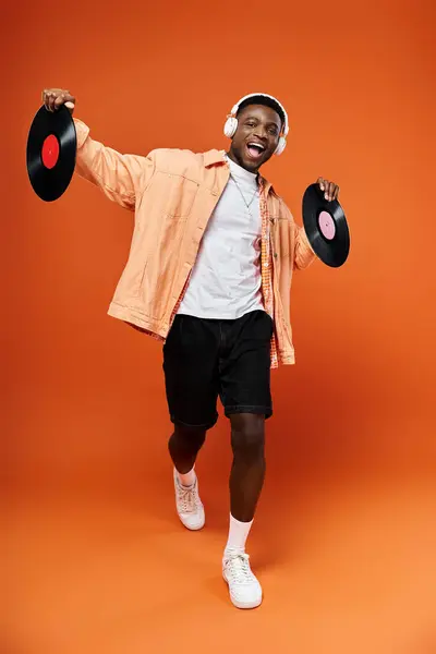 Stylish man jubilantly holds a record in the air. — Stock Photo