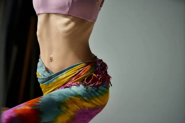 Stylish young woman in colorful tie-dyed skirt striking a pose. — Fotografia de Stock