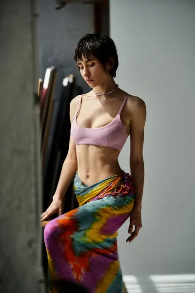 Enthusiastic young woman in colorful skirt striking a pose. — Stock Photo