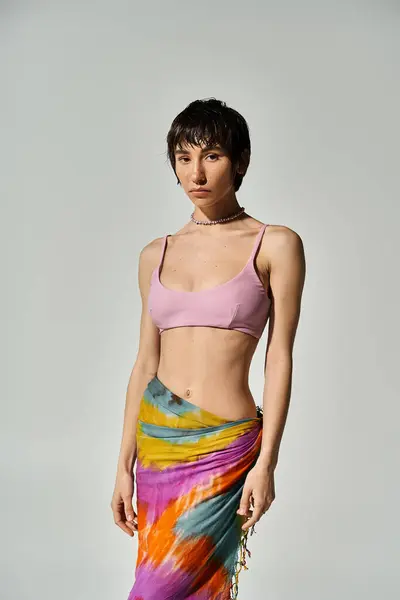 Young woman in colorful tie dye skirt posing confidently for a shot. — Stock Photo