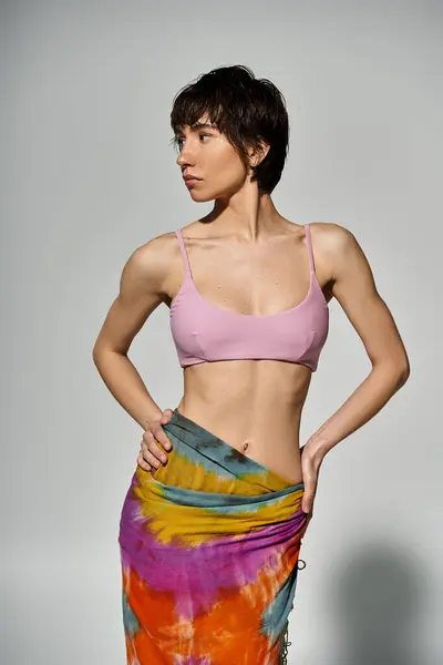 A young woman striking a pose in a stylish pink bikini. — Stock Photo