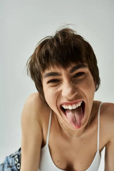 Young woman playfully sticking out her tongue. — стоковое фото