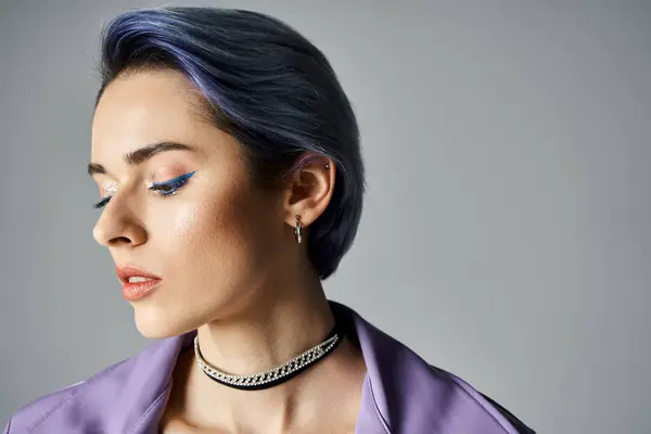 A young woman with blue hair styled in a trendy purple shirt poses confidently in a studio setting. — Fotografia de Stock