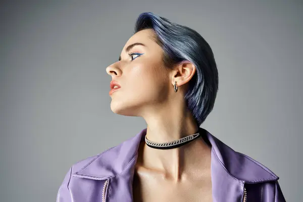 A young woman with striking blue hair striking a pose in a sleek purple jacket, exuding style and charisma. — Stock Photo