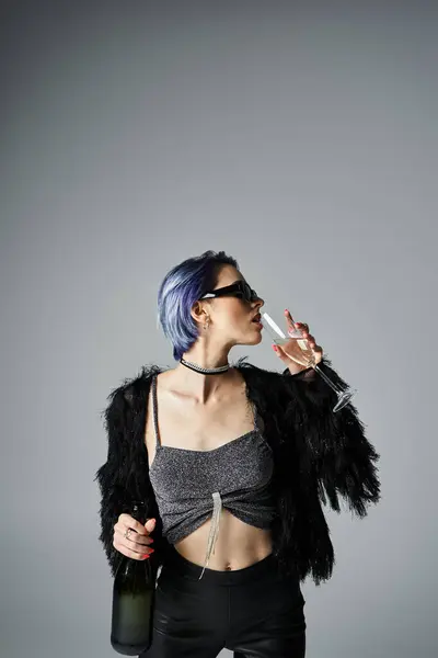 A young woman with blue hair elegantly drinking champagne — Stock Photo