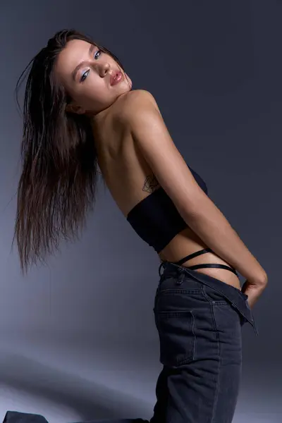 A young woman striking a pose as her hair gracefully flows in the wind. — Foto stock