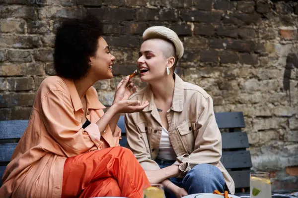 Two diverse, beautiful lesbians enjoying a coffee date in a stylish cafe. — Stock Photo