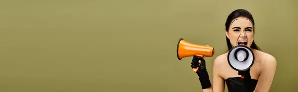 Surprised brunette pop art woman holds megaphone wearing black gloves. — Stock Photo