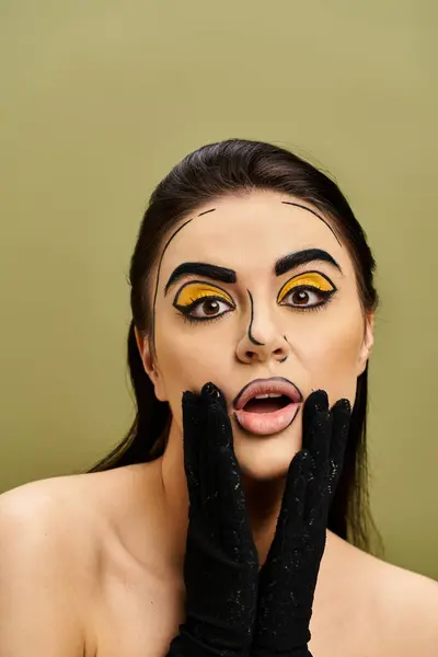 A striking brunette woman gazes with yellow eyes, adorned in pop art makeup and elegant black gloves. — Stock Photo