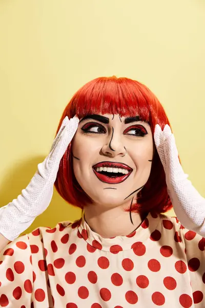 A vibrant redhead woman wears a polka dot dress and white gloves on a yellow background resembling a pop art character. — Stock Photo