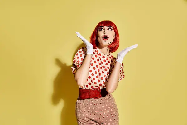 A stylish redhead in white gloves showcases pop art makeup, donning a polka dot blouse against a vibrant yellow backdrop. — Stock Photo