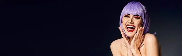 A pretty woman with purple hair and pop art makeup strikes a confident pose against a black background. — Stock Photo