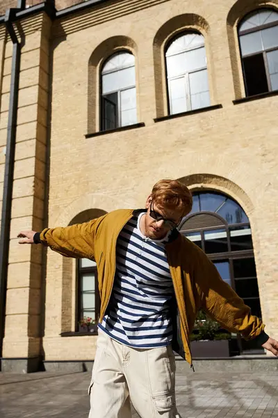 Stylish man with red hair taking walking in city sidewalk. — Stock Photo