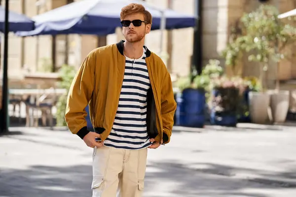 Stylish red-haired man confidently posing on city street. — Stock Photo