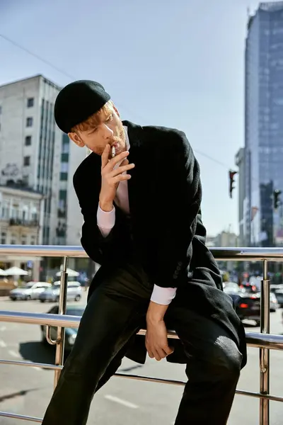 Elegant man in suit and hat smoking a cigarette. — Stock Photo