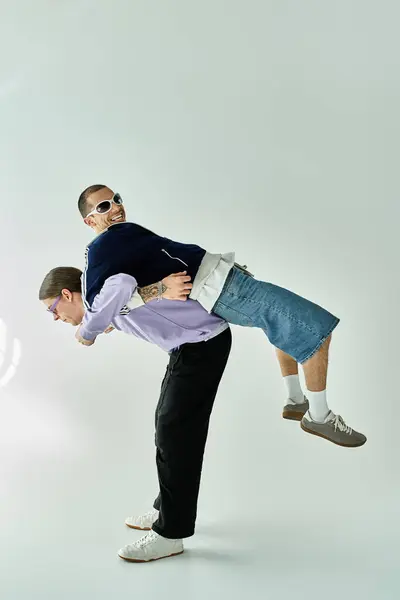 A man lifts his partner joyously into the air. — Stock Photo