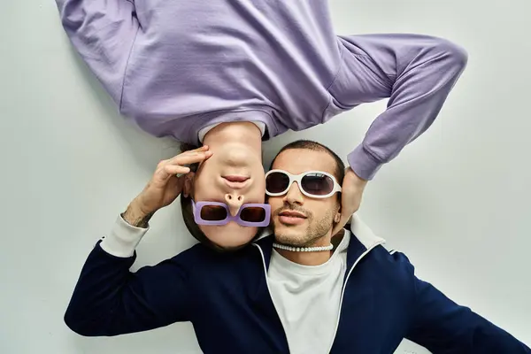 Two men intertwined, laying atop each other in a close embrace. — Stock Photo