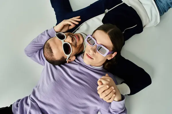 A couple of people laying on floor, spending quality time together. — Stock Photo