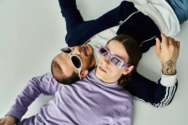 Two men lying intertwined in a loving embrace. — Stock Photo