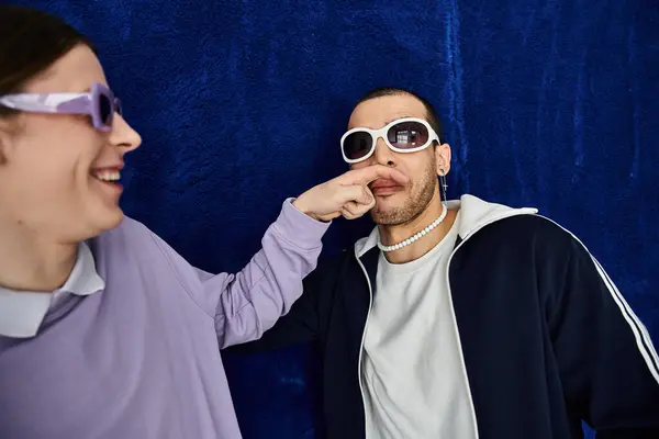 Man in sunglasses and his partner covering eyes, sharing a moment together. — Stock Photo