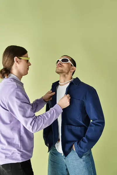 Two men stand before a vibrant yellow backdrop. — Stock Photo