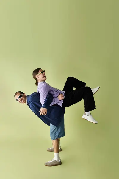 Two men posing peacefully before a vibrant yellow backdrop. — Stock Photo