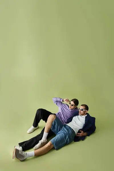 Two men lovingly embrace each other while laying on top of one another. — Stock Photo