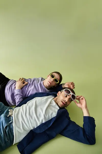Two men lying near each other, showing their affection. — Stock Photo