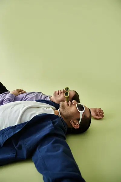 Two men in close embrace on the ground, sharing a moment of connection and vulnerability. — Stock Photo