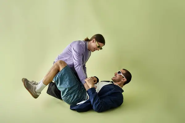 A man gracefully balances on top of another man in a harmonious display of balance and strength. — Stock Photo