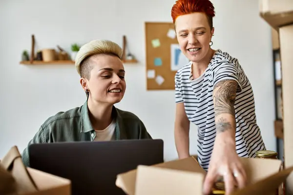 Couple examine various boxes, possibly during a volunteering activity. — Stock Photo