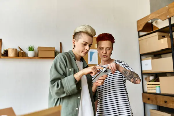 Two women, a young lesbian couple, stand side by side, collaborating on charity work. — Stock Photo