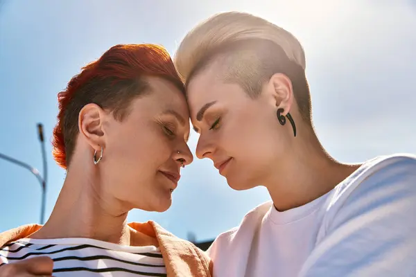 A young lesbian couple proudly stands side by side outdoors, symbolizing love and pride. — Stock Photo