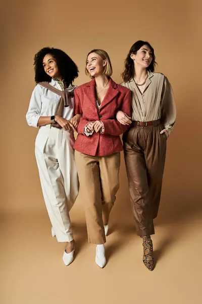 Three young beautiful women in stylish attire and diverse backgrounds posing together. — Stock Photo