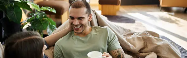 A young gay couple relaxes in bed, enjoying a morning together. — Stock Photo