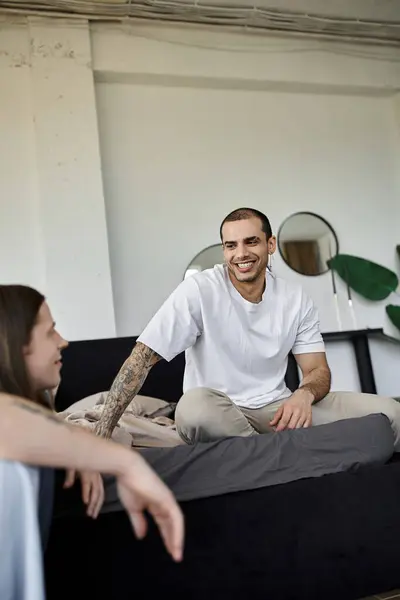 A young gay couple spends quality time together, relaxing on a bed in a bedroom. — Stock Photo