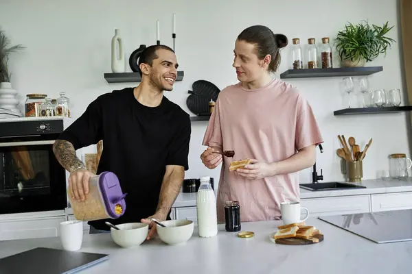 Two young men, a gay couple, prepare breakfast together in a modern kitchen. — Stock Photo