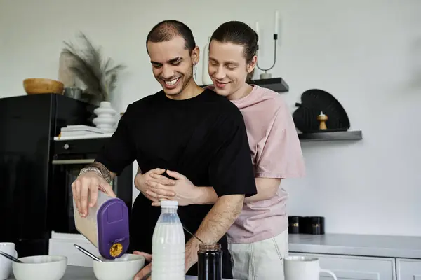 A young gay couple makes breakfast together in their modern kitchen. — Stock Photo