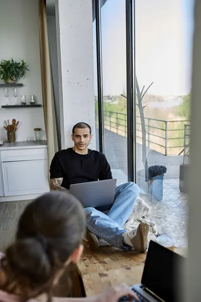 A young gay couple relaxes in their modern home, enjoying quality time together. — Stock Photo