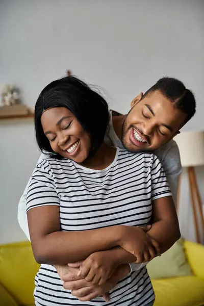 A happy African American couple embraces at home. — Stock Photo